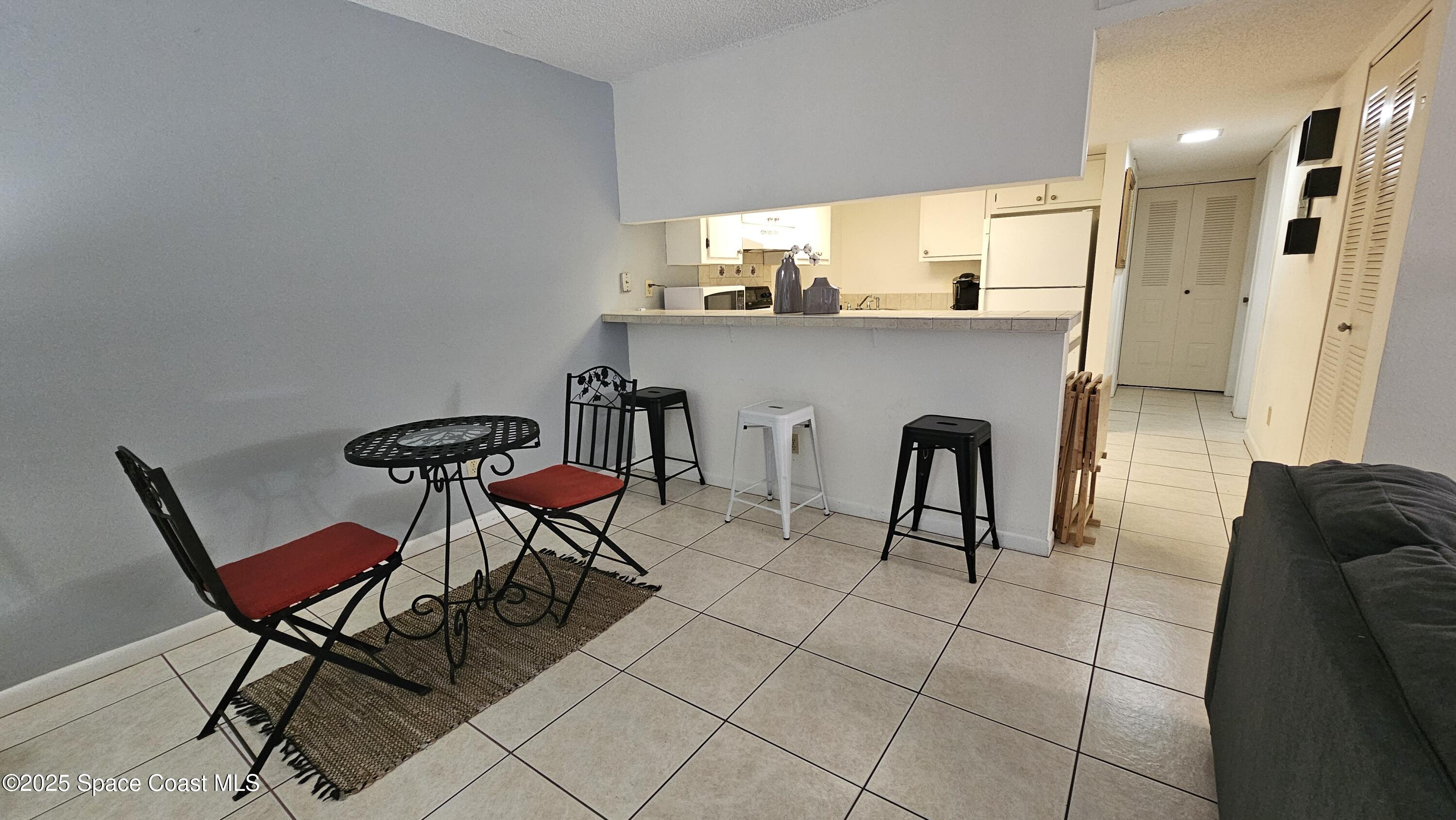 1641 Sunny Brook Lane, Unit C201 Palm Bay, FL 32905 - Photo 5 of 19 a living room with furniture and a dining table