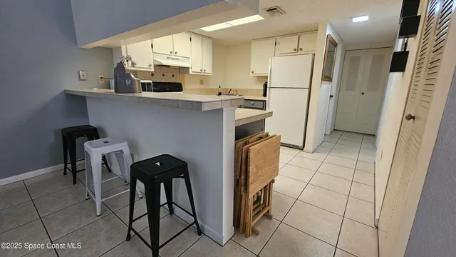 a kitchen with stainless steel appliances a refrigerator and a stove top oven