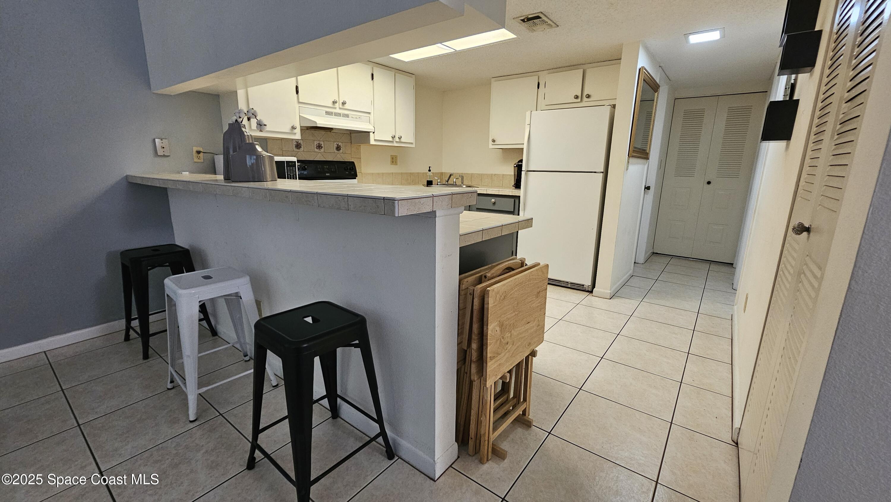 1641 Sunny Brook Lane, Unit C201 Palm Bay, FL 32905 - Photo 6 of 19 a kitchen with stainless steel appliances a refrigerator and a stove top oven
