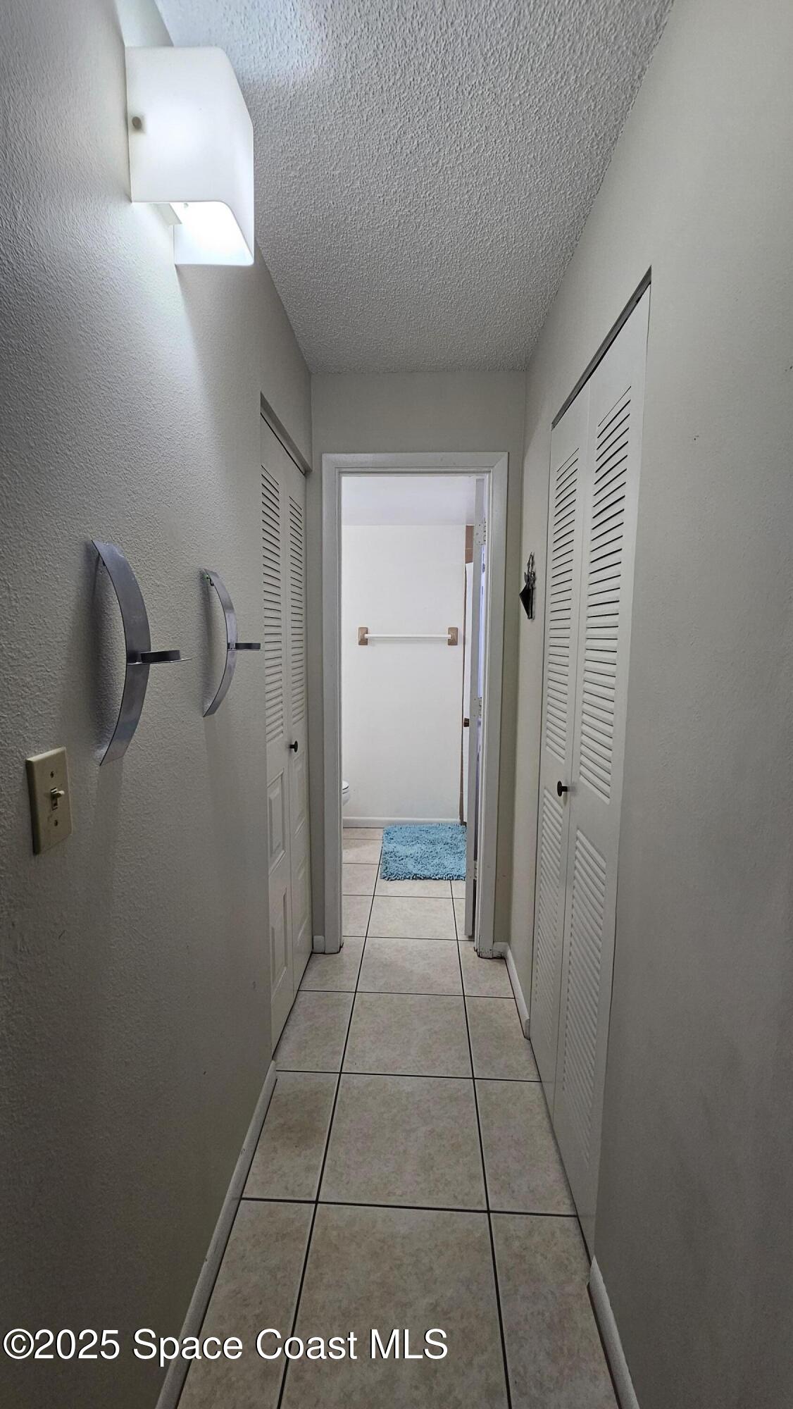1641 Sunny Brook Lane, Unit C201 Palm Bay, FL 32905 - Photo 10 of 19 a view of a hallway