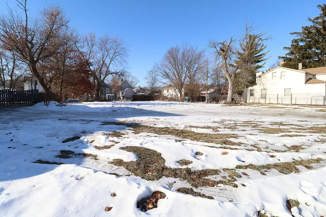 a view of a yard with snow on the road