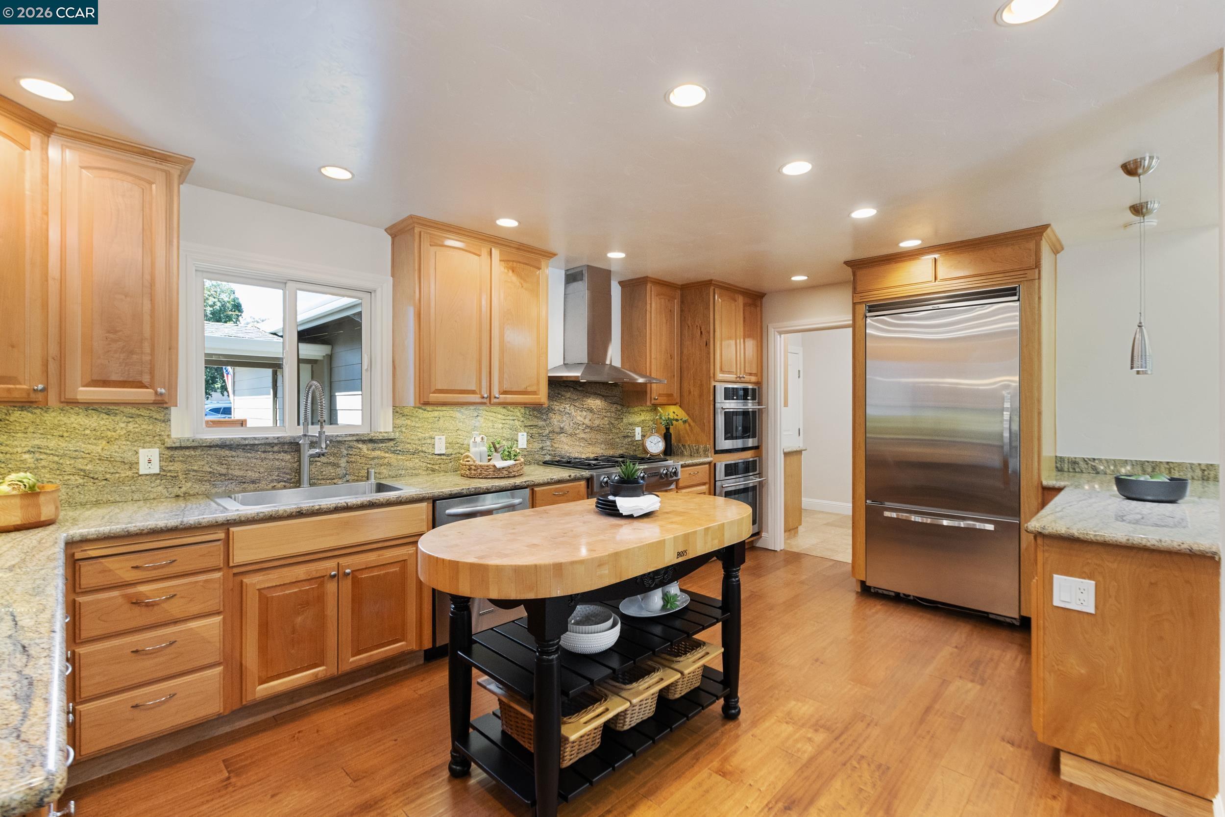 484 Diablo Road Danville, CA 94526 - Photo 13 of 39 a kitchen with a refrigerator a sink and cabinets