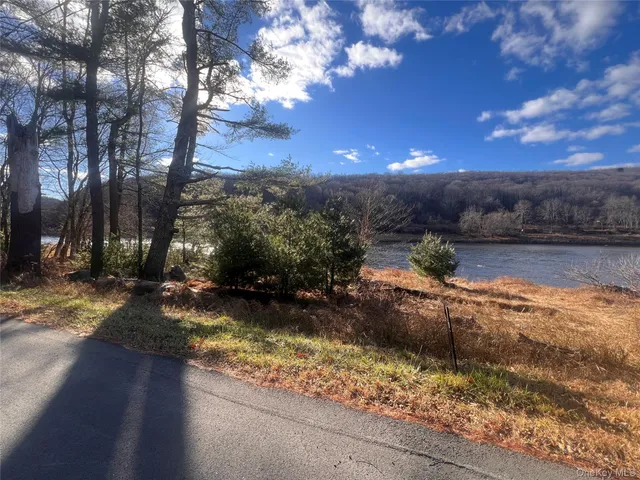 a view of a yard with wooden fence