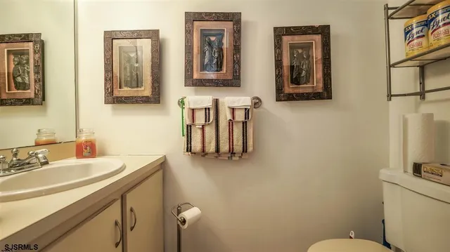 a living room with furniture a ceiling fan and a window