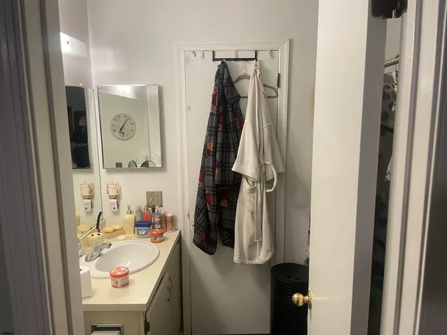 a bathroom with a sink vanity and a mirror