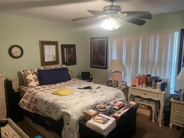 a bedroom with bed and a chandelier