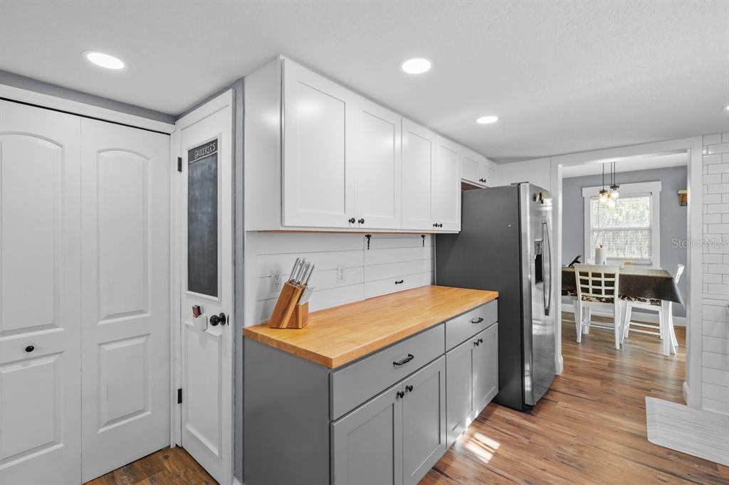 240 Whirlwind Loop Hawthorne, FL 32640 - Photo 11 of 39 a kitchen with stainless steel appliances a refrigerator and wooden floor