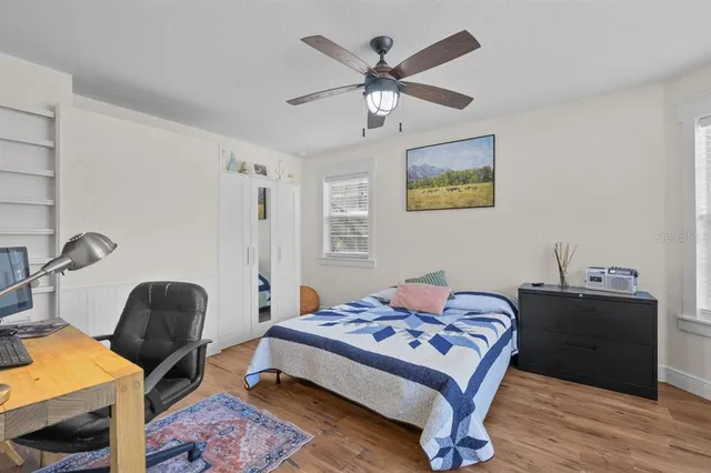 a bedroom with a bed and a chandelier
