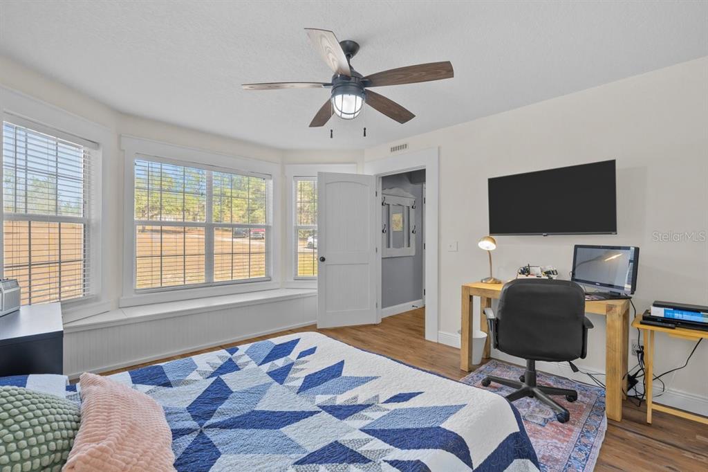 240 Whirlwind Loop Hawthorne, FL 32640 - Photo 15 of 39 a bedroom with a bed and a flat screen tv