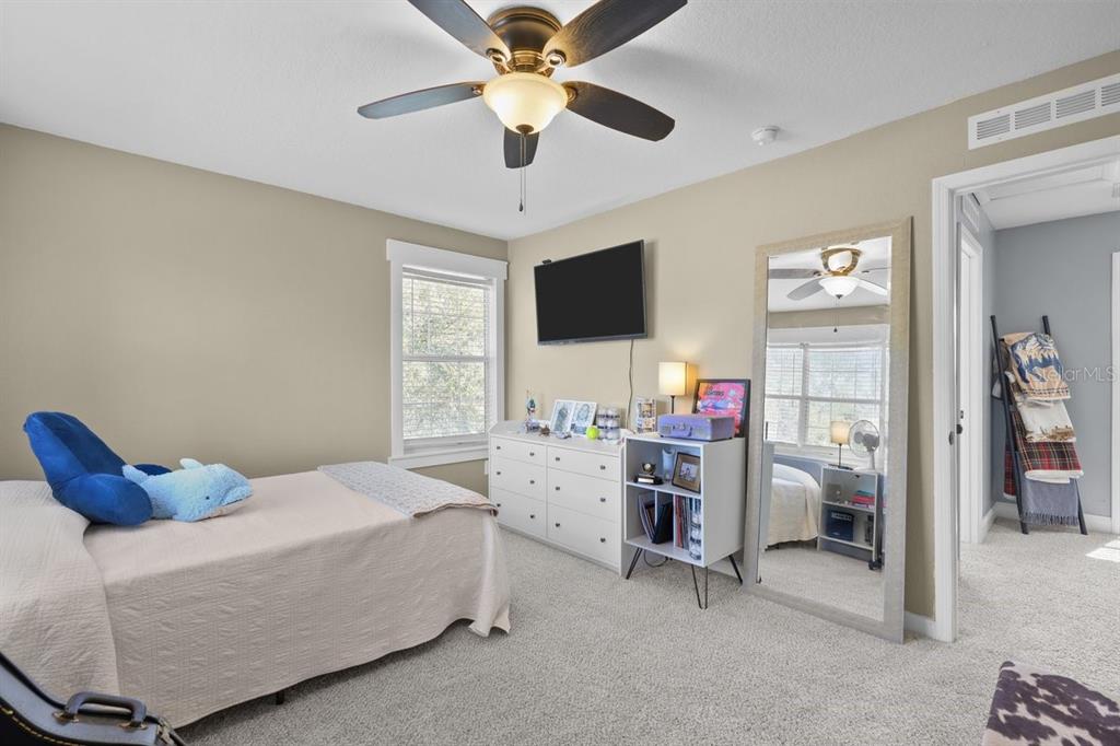 240 Whirlwind Loop Hawthorne, FL 32640 - Photo 20 of 39 a bedroom with a bed and a flat screen tv