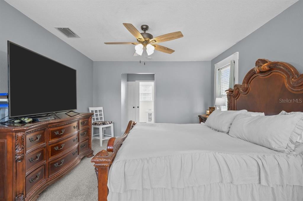 240 Whirlwind Loop Hawthorne, FL 32640 - Photo 22 of 39 a bedroom with a bed and a flat screen tv