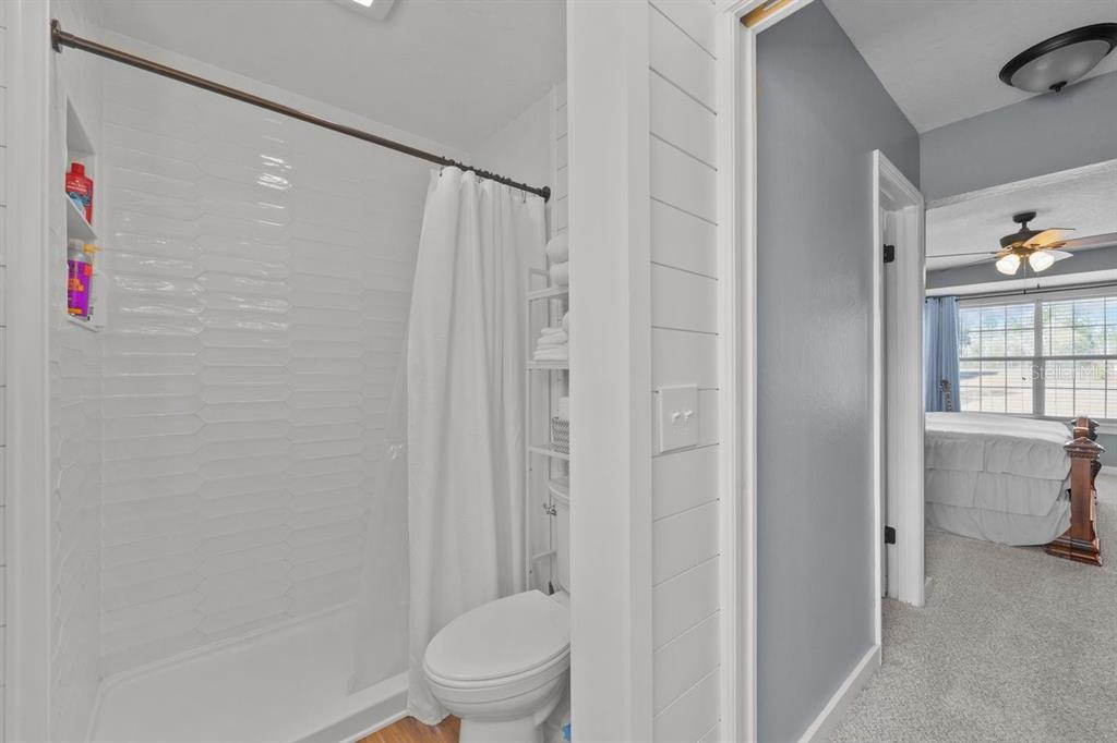 240 Whirlwind Loop Hawthorne, FL 32640 - Photo 24 of 39 a bathroom with a shower and a toilet