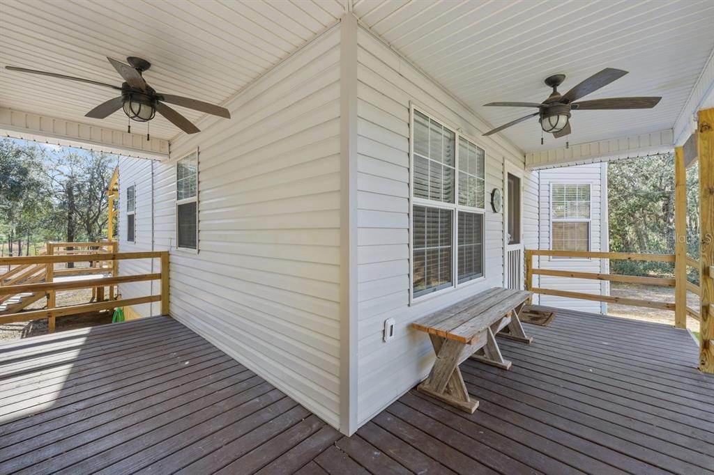 240 Whirlwind Loop Hawthorne, FL 32640 - Photo 25 of 39 a view of a room with wooden floor and a ceiling fan