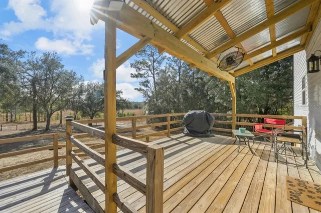 a view of balcony with wooden floor and outdoor seating