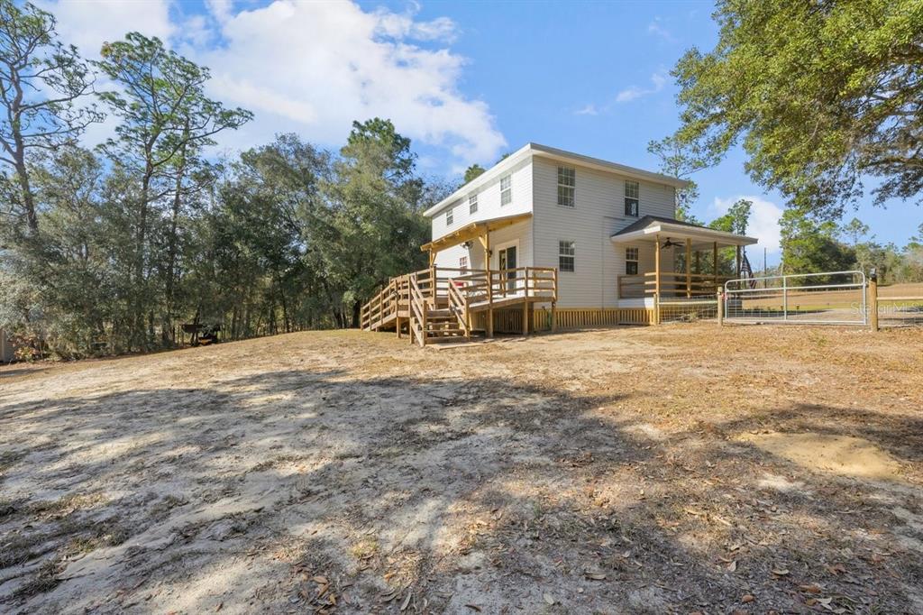 240 Whirlwind Loop Hawthorne, FL 32640 - Photo 28 of 39 a view of a house with a yard