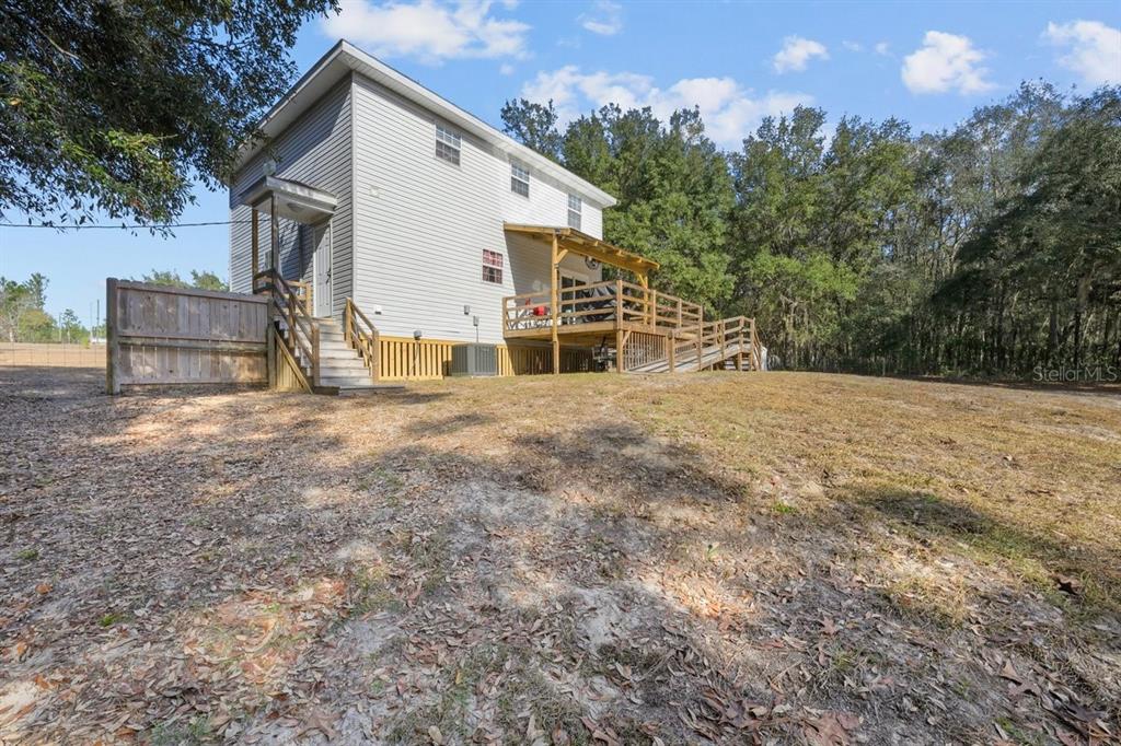 240 Whirlwind Loop Hawthorne, FL 32640 - Photo 29 of 39 a view of a house with backyard and sitting area