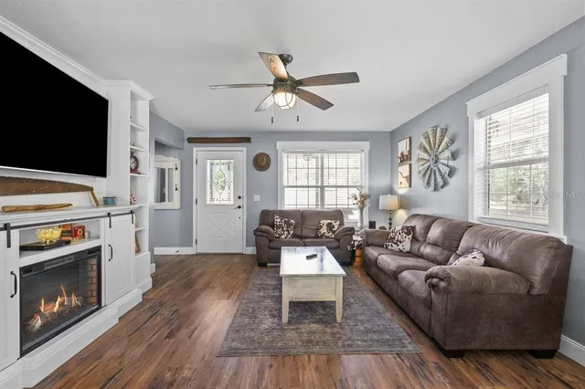a living room with furniture fireplace and window