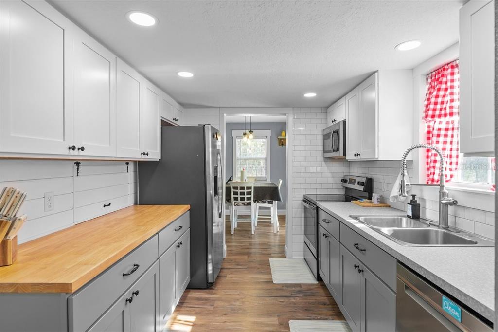240 Whirlwind Loop Hawthorne, FL 32640 - Photo 9 of 39 a kitchen with stainless steel appliances granite countertop a sink and cabinets