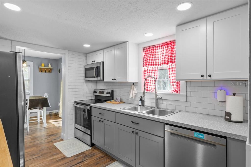 240 Whirlwind Loop Hawthorne, FL 32640 - Photo 10 of 39 a kitchen with a sink cabinets and window