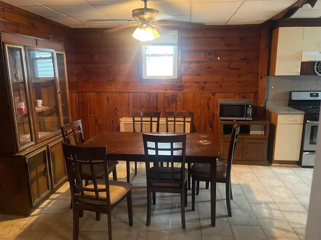 a view of a dining room with furniture and chandelier