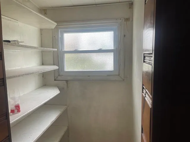 a bathroom with a window and a toilet