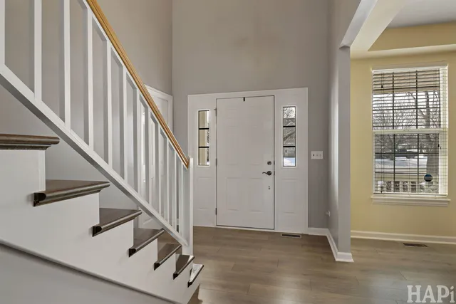 a view of an entryway with wooden floor and door