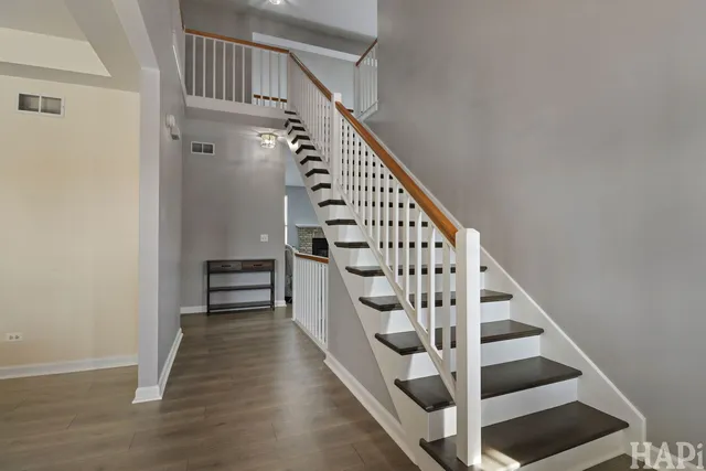 a view of entryway and hall with wooden floor
