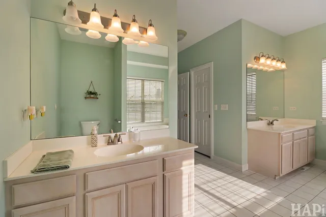 a bathroom with a sink vanity and a mirror