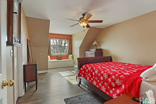 a bedroom with a bed dresser and a window