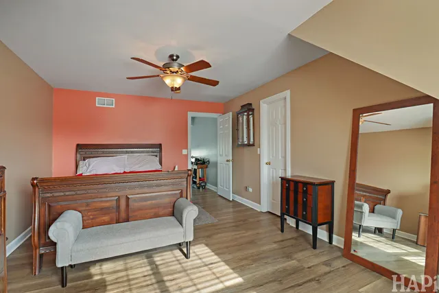 a bedroom with furniture and a mirror