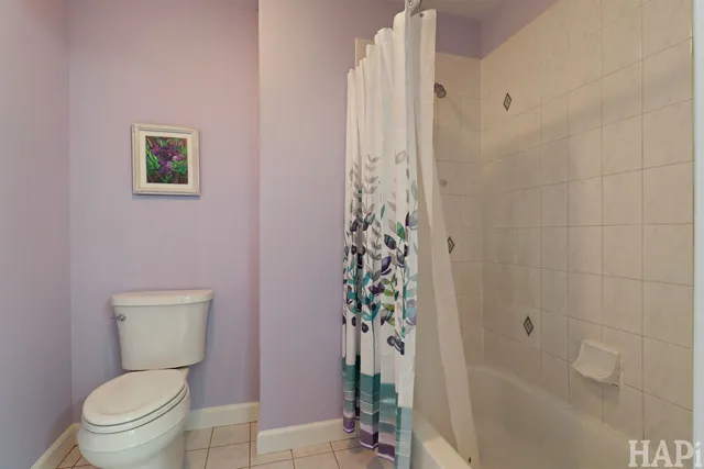 a white toilet sitting next to a bath tub