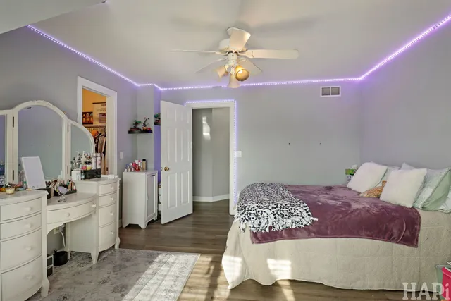 a bedroom with a bed dresser and a mirror