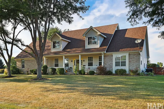 a front view of house with yard and trees around