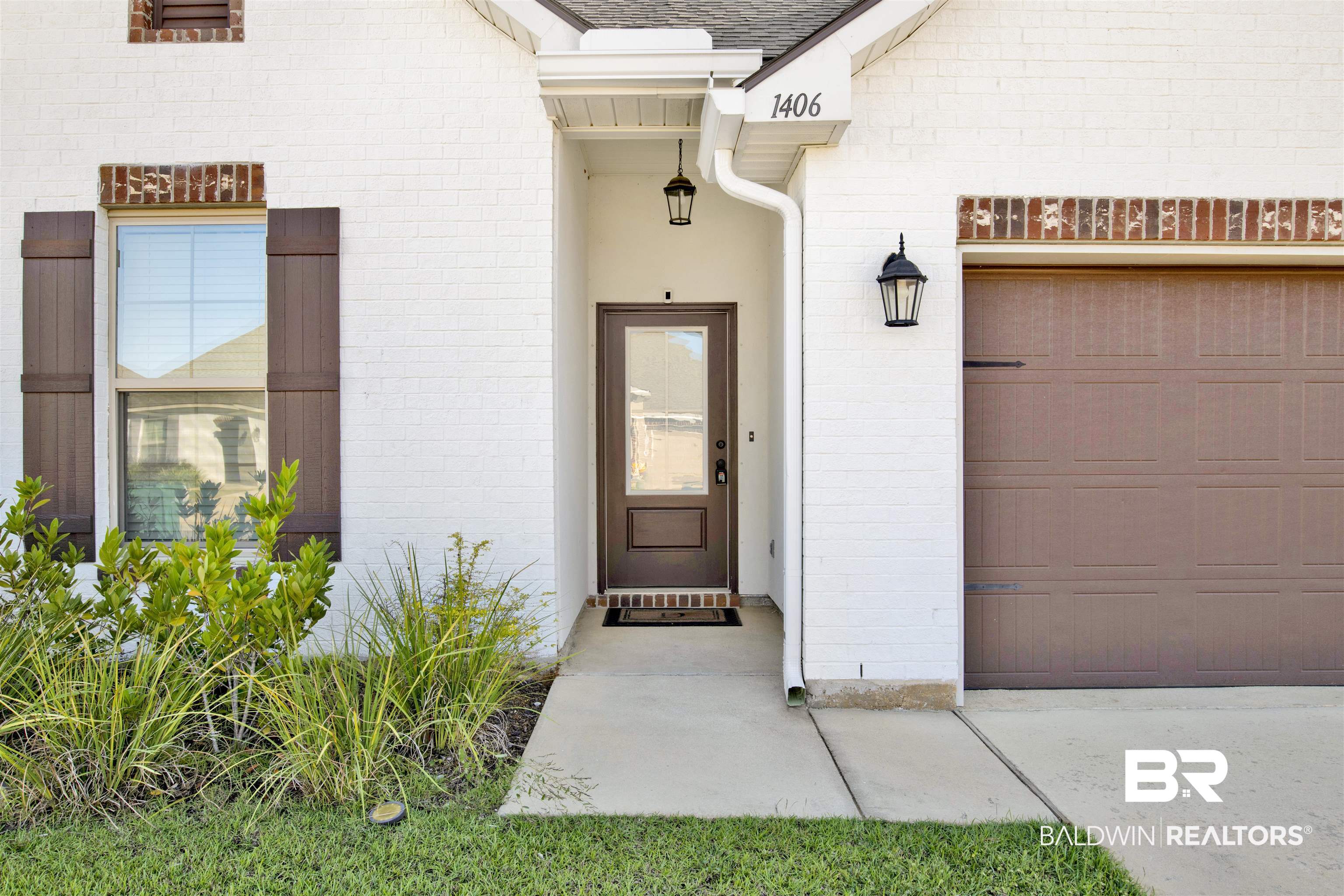 1406 Aldon Street Foley, AL 36535 - Photo 4 of 30 View of exterior entry featuring a garage