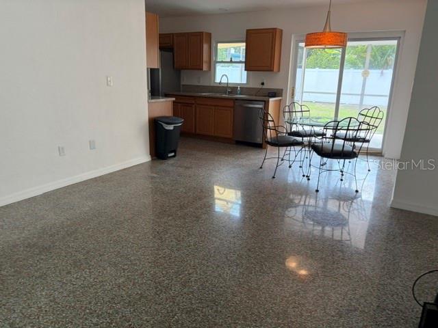 11601 109th Street Seminole, FL 33778 - Photo 7 of 29 a kitchen with stainless steel appliances a table chairs in it and a window