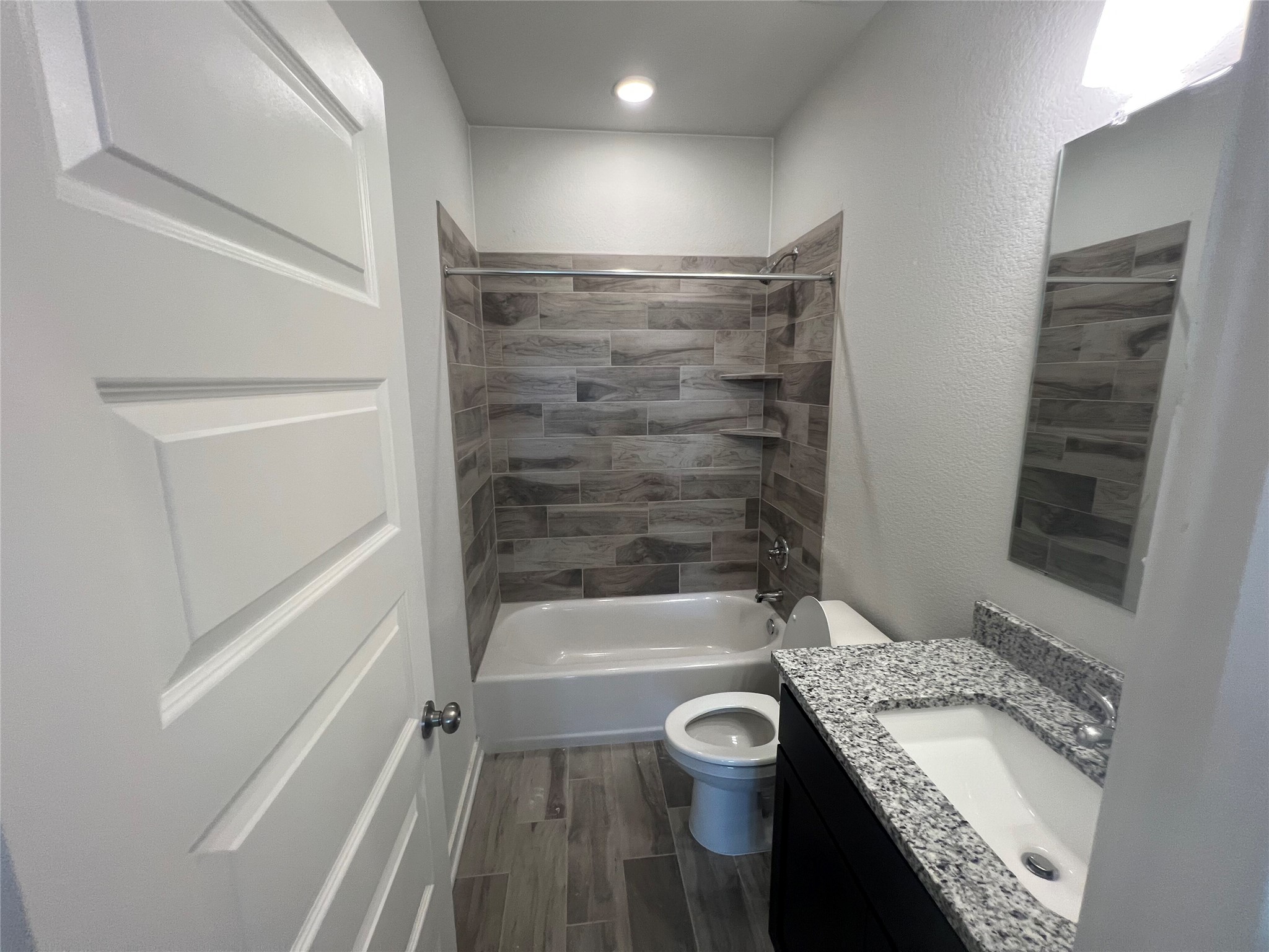 255 Gus Loop Georgetown, TX 78626 - Photo 7 of 24 Modern bath with granite counters, tile flooring, and a tiled shower.