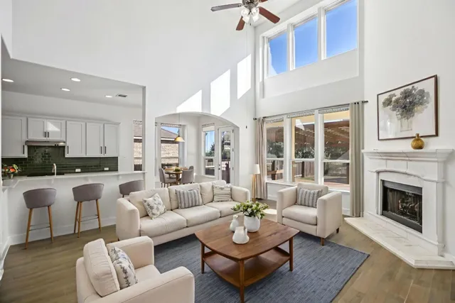 a living room with furniture fireplace and a table