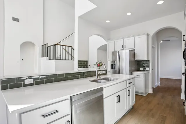 a kitchen with a sink cabinets and stainless steel appliances