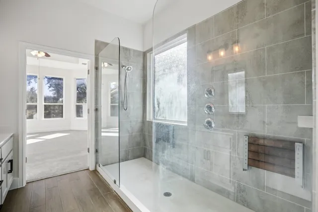 a bathroom with a double vanity sink a mirror and a shower