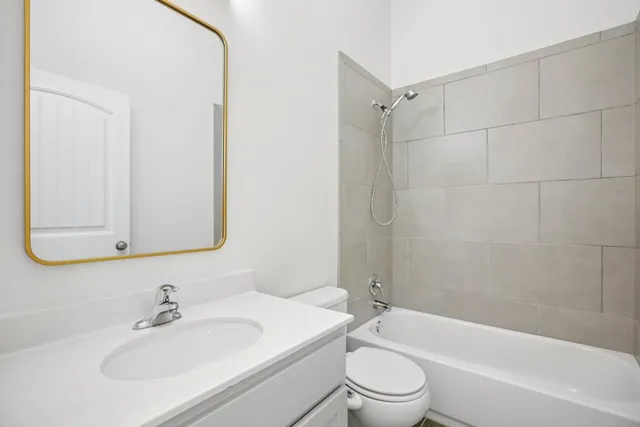 a bathroom with a sink toilet and vanity