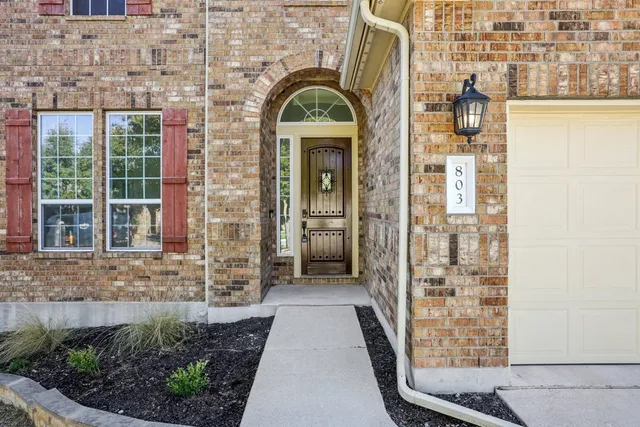 a view of a brick house with a large windows