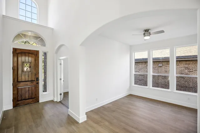 an empty room with windows and closet