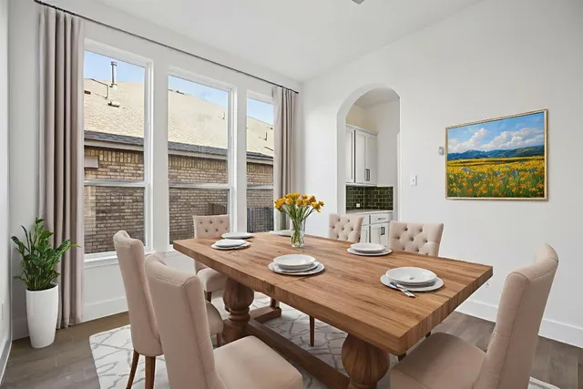 a view of a dining room with furniture window and wooden floor