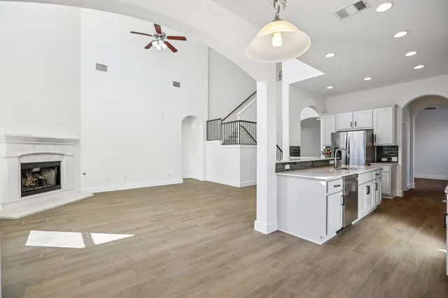 a kitchen with stainless steel appliances granite countertop a refrigerator a oven a sink and a stove