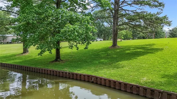 a view of a lake with a yard