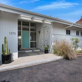 front view of a house with potted plants