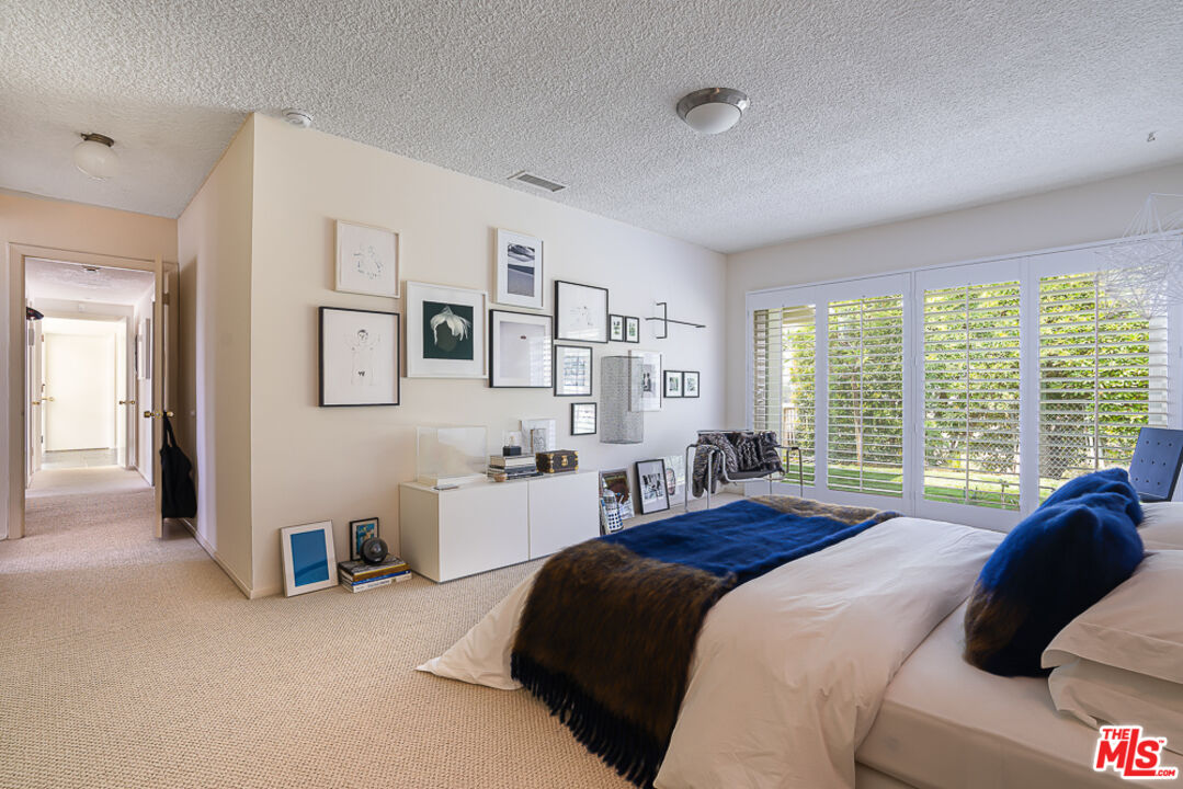 1373 Las Canoas Road Pacific Palisades, CA 90272 - Photo 11 of 19 a bedroom with a bed and a large window