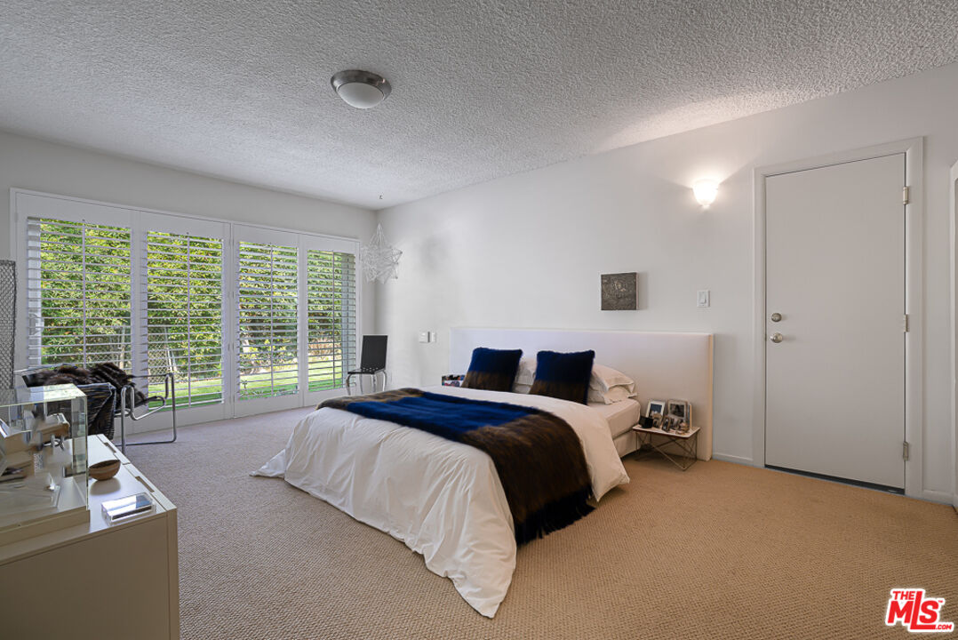 1373 Las Canoas Road Pacific Palisades, CA 90272 - Photo 12 of 19 a bed room with a bed and a large window