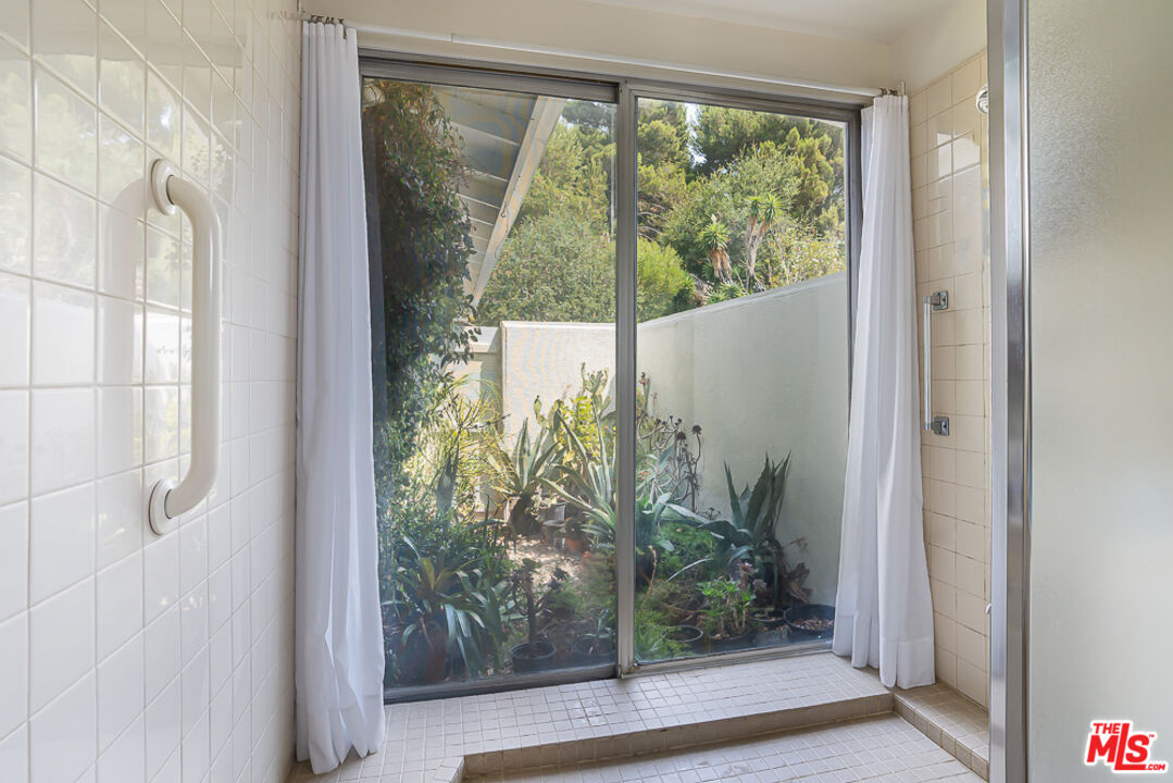 1373 Las Canoas Road Pacific Palisades, CA 90272 - Photo 13 of 19 a view of a glass door and porch