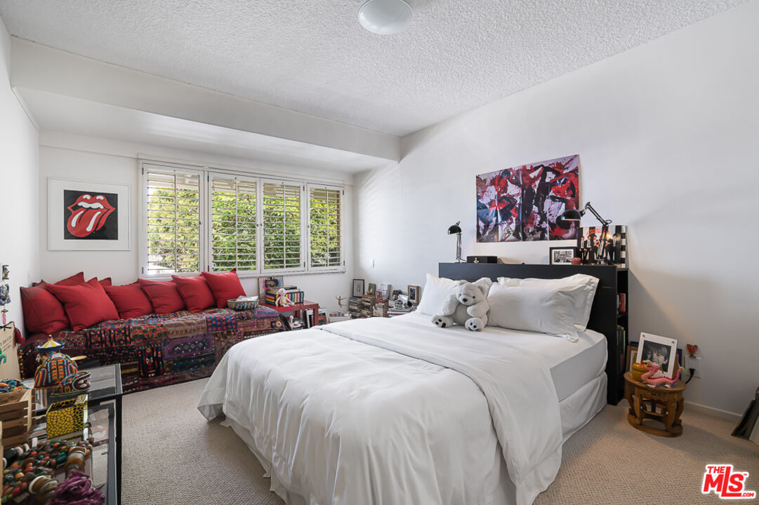 1373 Las Canoas Road Pacific Palisades, CA 90272 - Photo 14 of 19 a bedroom with double bed and a large window